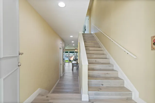 a view of entryway and hall with wooden floor