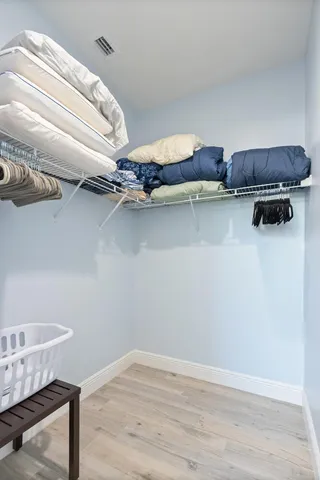 a view of a room with racks and a book shelf