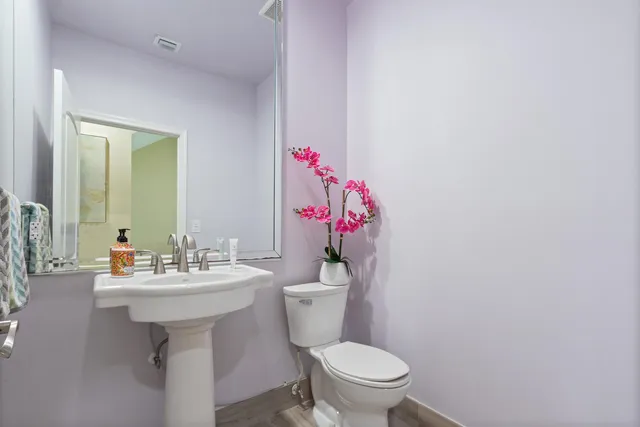 a bathroom with a sink mirror and toilet