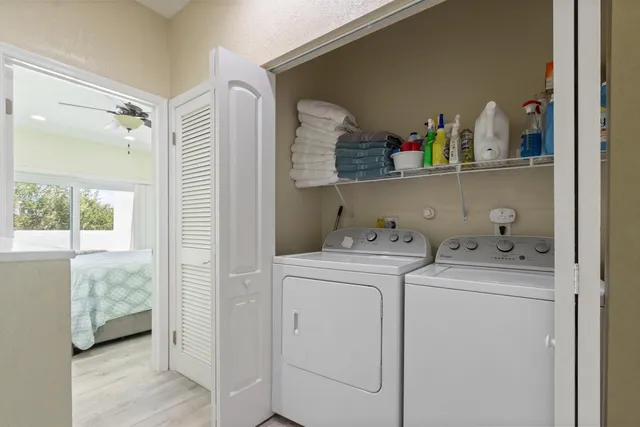 a view of storage and utility room with washer and dryer