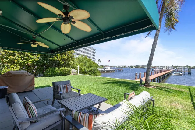 a view of a patio with a table chairs and a backyard