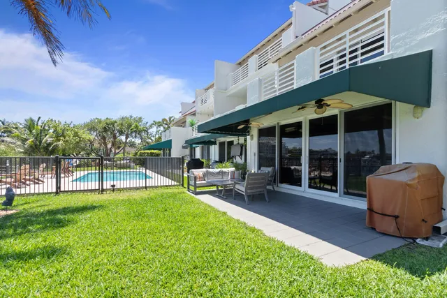 a view of a house with backyard porch and sitting area