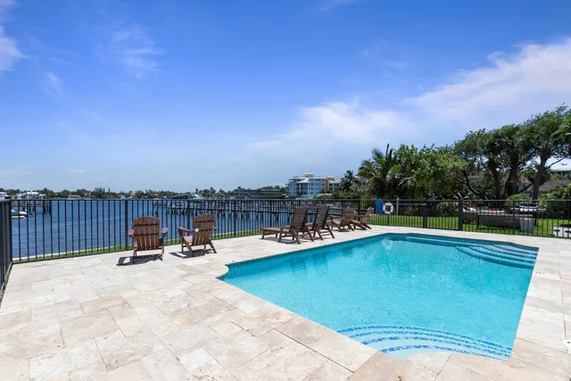 a view of a swimming pool and lounge chairs