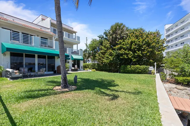 a view of a house with backyard porch and sitting area