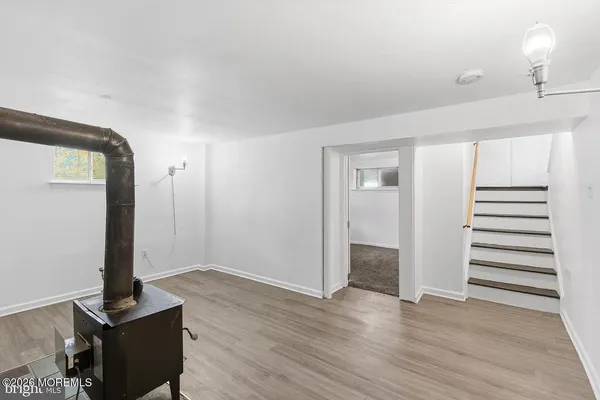 a view of a room with wooden floor