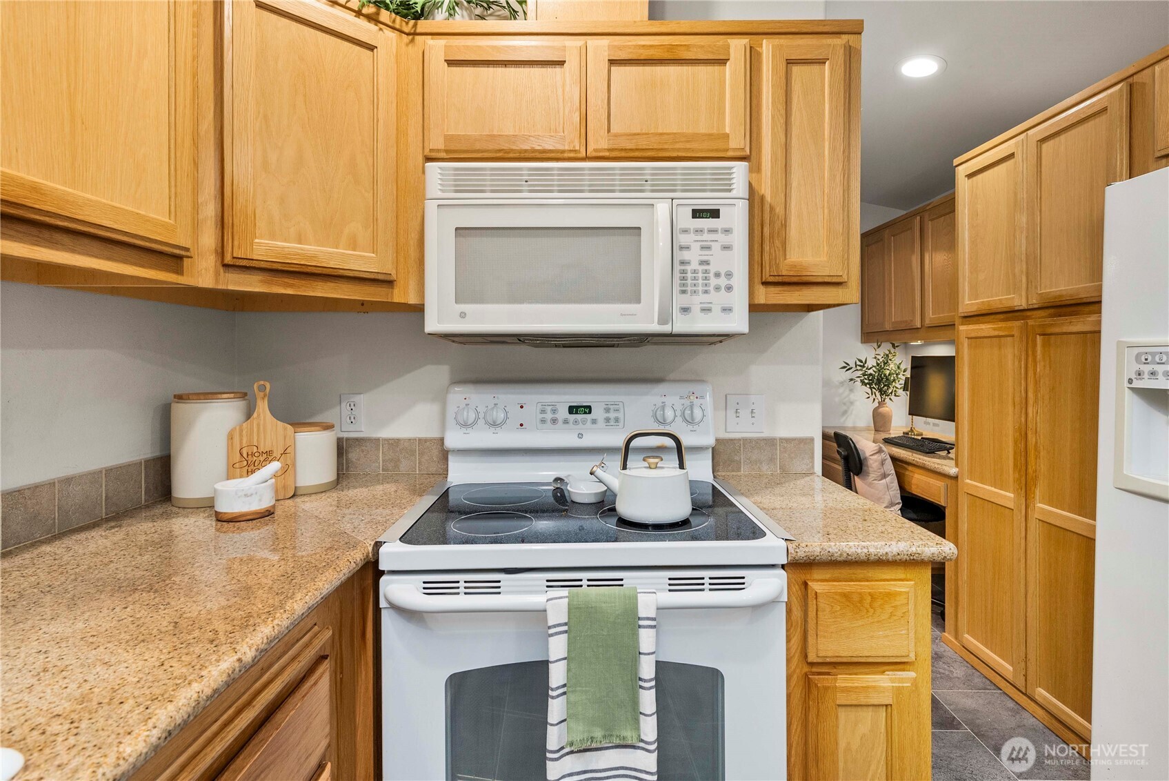 1546 Reservation Road Southeast, Unit 62 Olympia, WA 98513 - Photo 8 of 39 a kitchen with a stove and a refrigerator