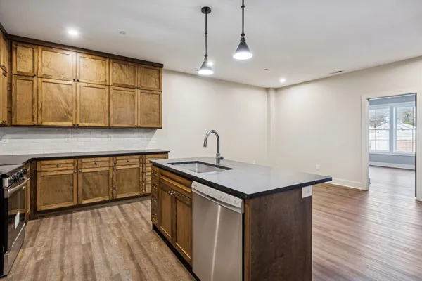 a kitchen with a sink window and cabinets