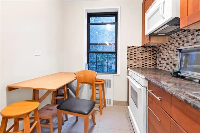 a view of a kitchen area with furniture and wooden floor