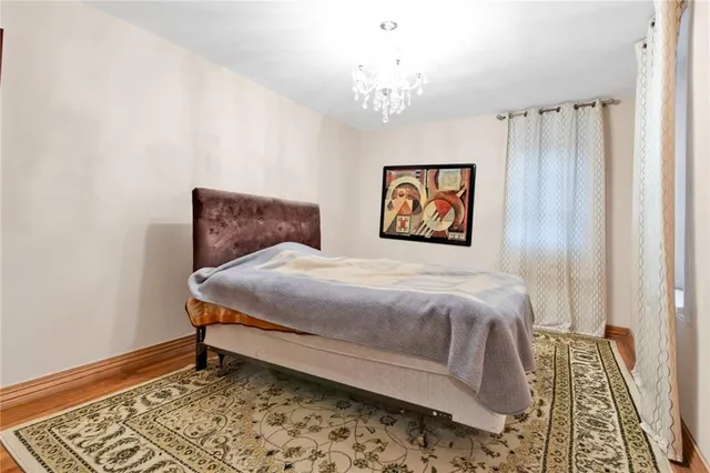 a bedroom with a bed and a chandelier