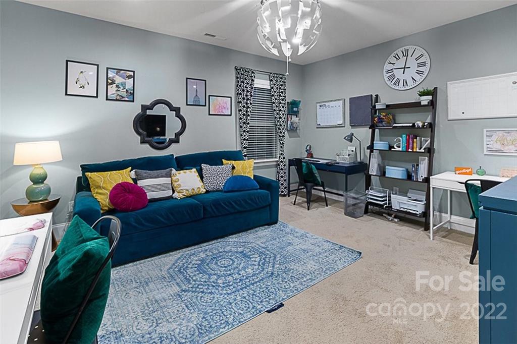 7001 Fallondale Road Waxhaw, NC 28173 - Photo 21 of 32 a living room with furniture and a chandelier