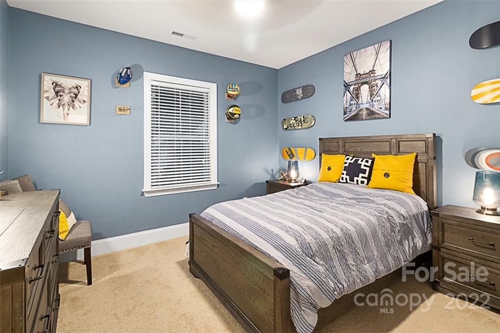 7001 Fallondale Road Waxhaw, NC 28173 - Photo 22 of 32 a bedroom with a bed and wooden floor