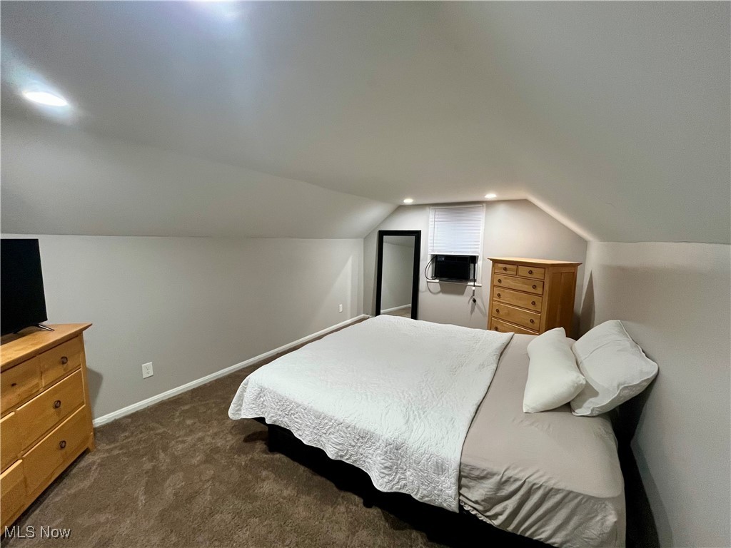 20907 Watson Road Maple Heights, OH 44137 - Photo 10 of 20 Bedroom with vaulted ceiling, dark colored carpet, and cooling unit