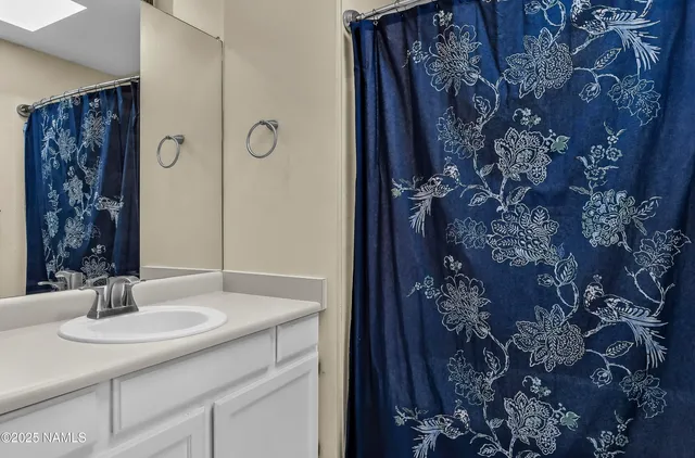 a bathroom with a sink and vanity