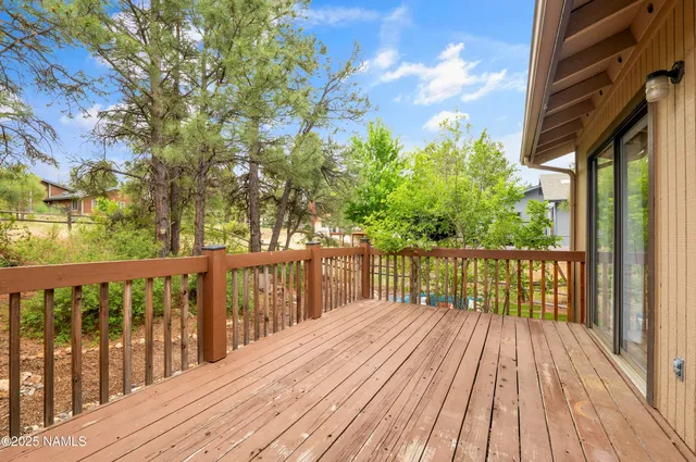 a balcony with wooden floor and fence