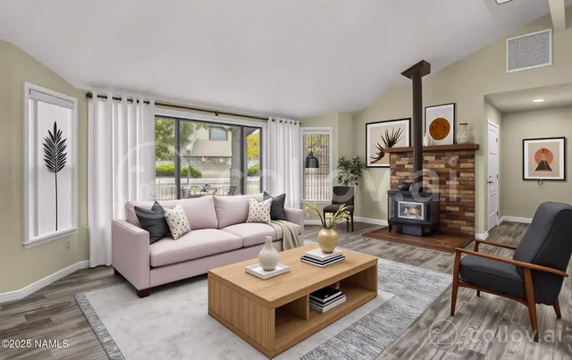 a living room with fireplace furniture and a large window