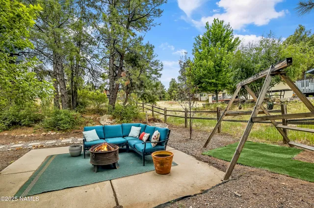 a view of a backyard with sitting area