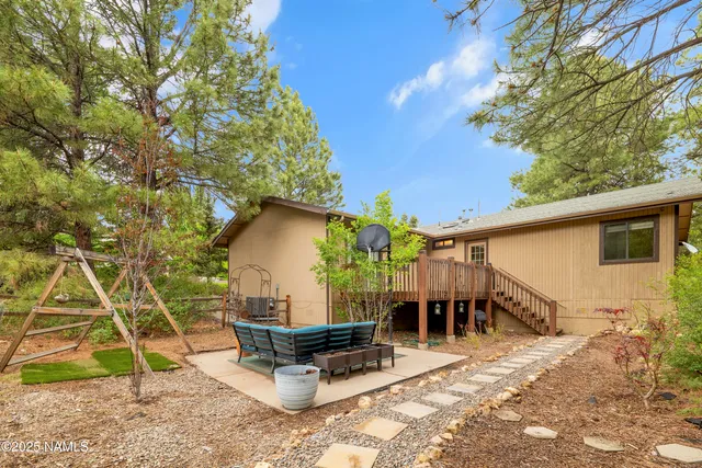 a view of a chairs and table in backyard