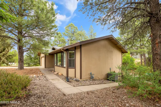 a view of a house with a yard covered in snow