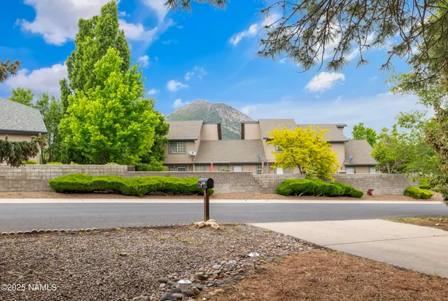 a front view of a house with a yard and a garage