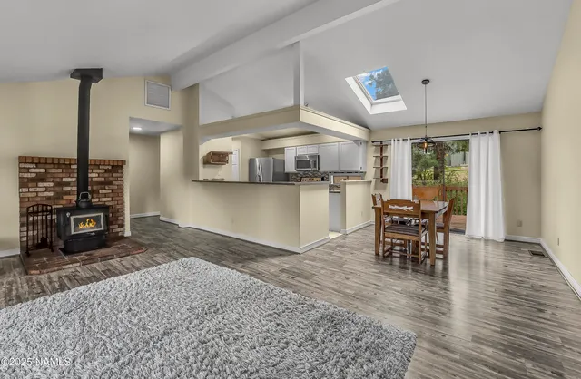 a view of a kitchen with dining area wooden floor and appliances