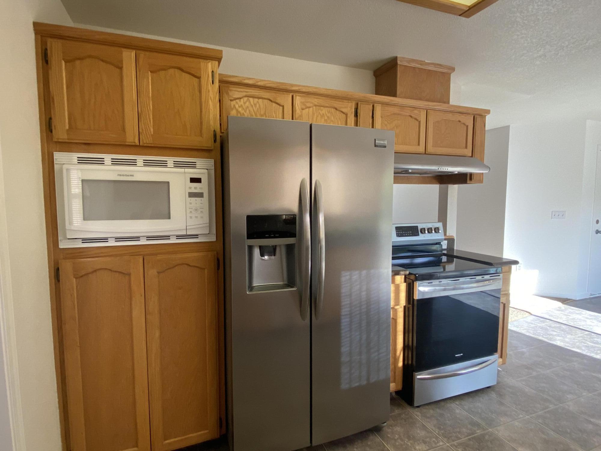 40855 Grouse Drive Three Rivers, CA 93271 - Photo 9 of 24 a kitchen with stainless steel appliances granite countertop a refrigerator and a stove top oven