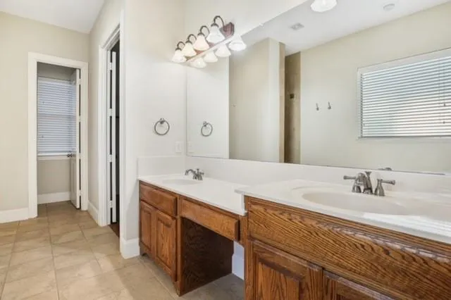 a bathroom with a sink double vanity and a mirror