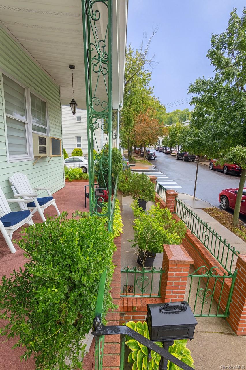85-52 79th Street Queens, NY 11421 - Photo 9 of 11 a view of a patio with couches table and chairs and potted plants