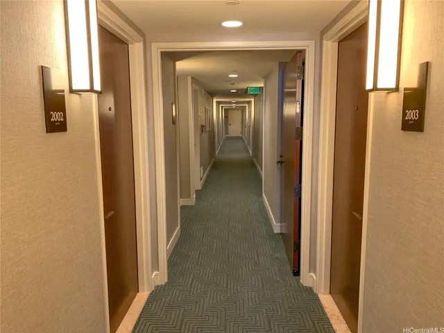 a view of a hallway with a door and couch