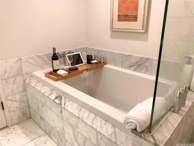 a white bath tub sitting in a bathroom