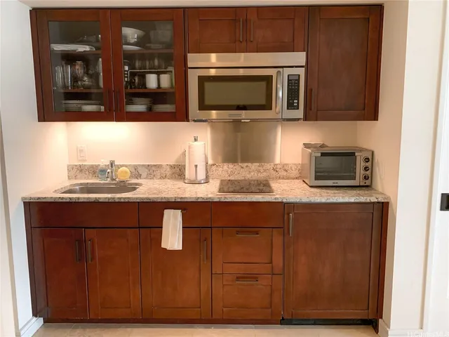 a kitchen with granite countertop wood cabinets and stainless steel appliances