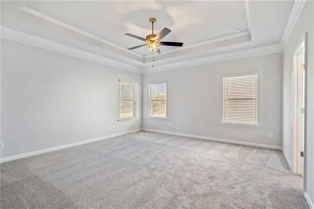 a view of a livingroom with a ceiling fan and window