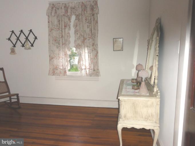a room with chandelier and wooden floor
