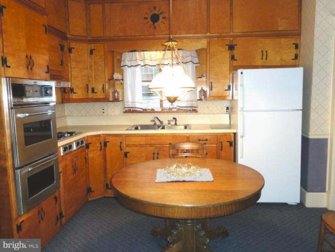 104 Sycamore Road Linthicum, MD 21090 - Photo 8 of 13 a kitchen with a sink a stove and a refrigerator