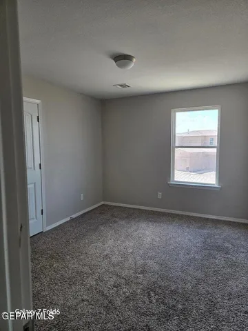 an empty room with a empty space and windows