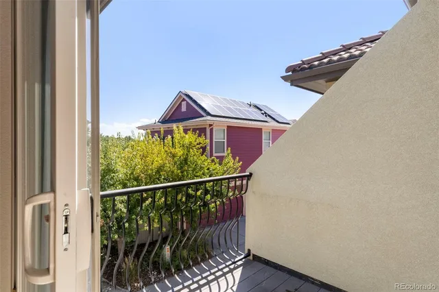 a view of a balcony with a yard