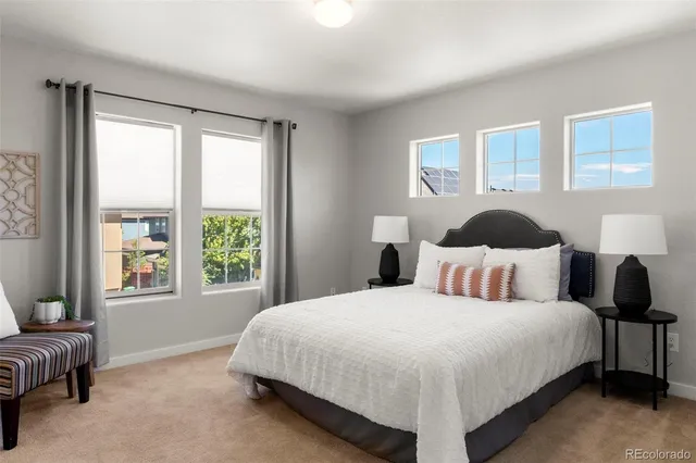 a bedroom with a bed lamp and a window