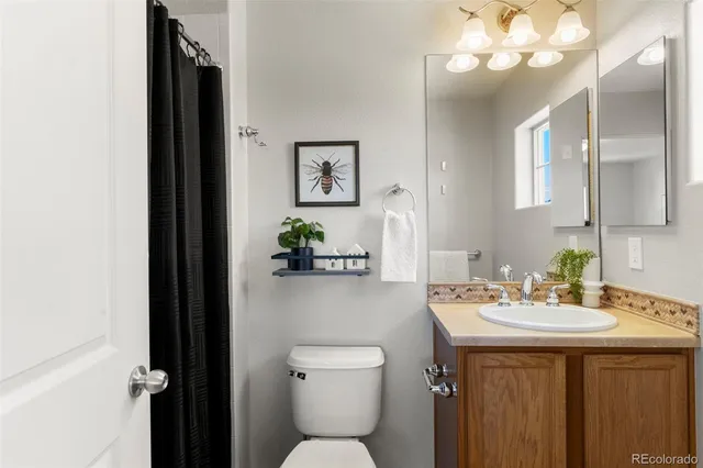 a bathroom with a sink vanity and a mirror
