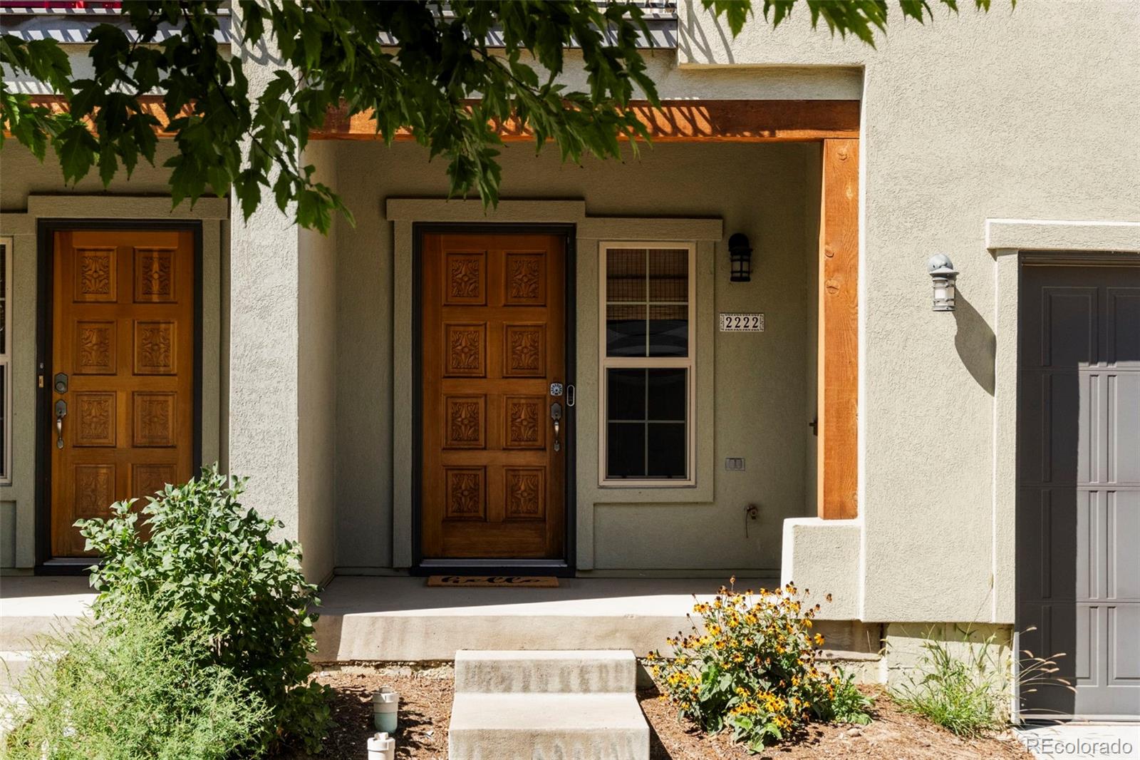 2222 Valentia Street Denver, CO 80238 - Photo 23 of 26 front view of a house with a potted plant and a potted plant