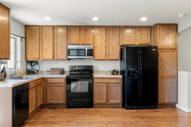 a kitchen with stainless steel appliances granite countertop a refrigerator and a stove top oven
