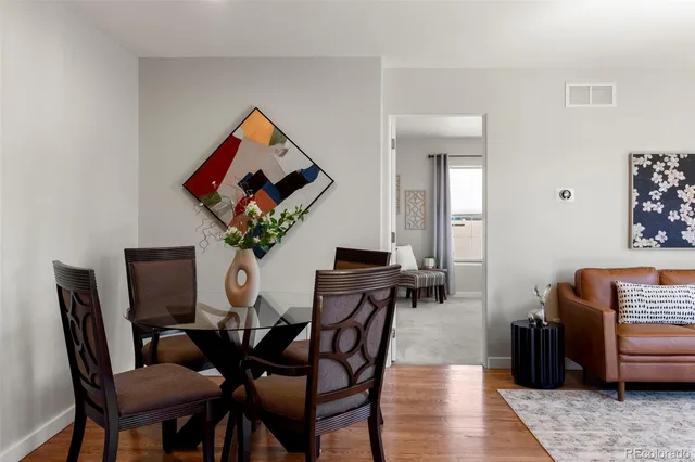 a dining room with furniture and wooden floor