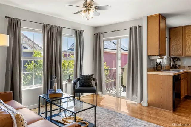 a living room with furniture and large windows