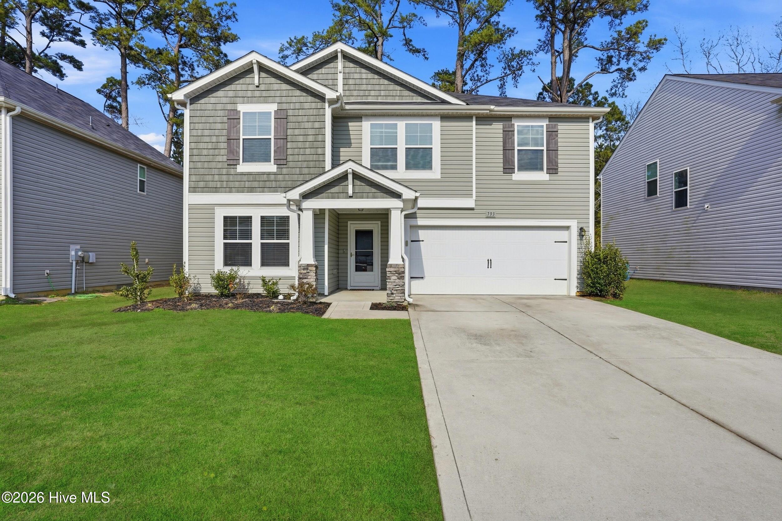 Attractive front elevation featuring a blend of shaker and vinyl siding, creating a timeless and low-maintenance exterior with strong curb appeal.