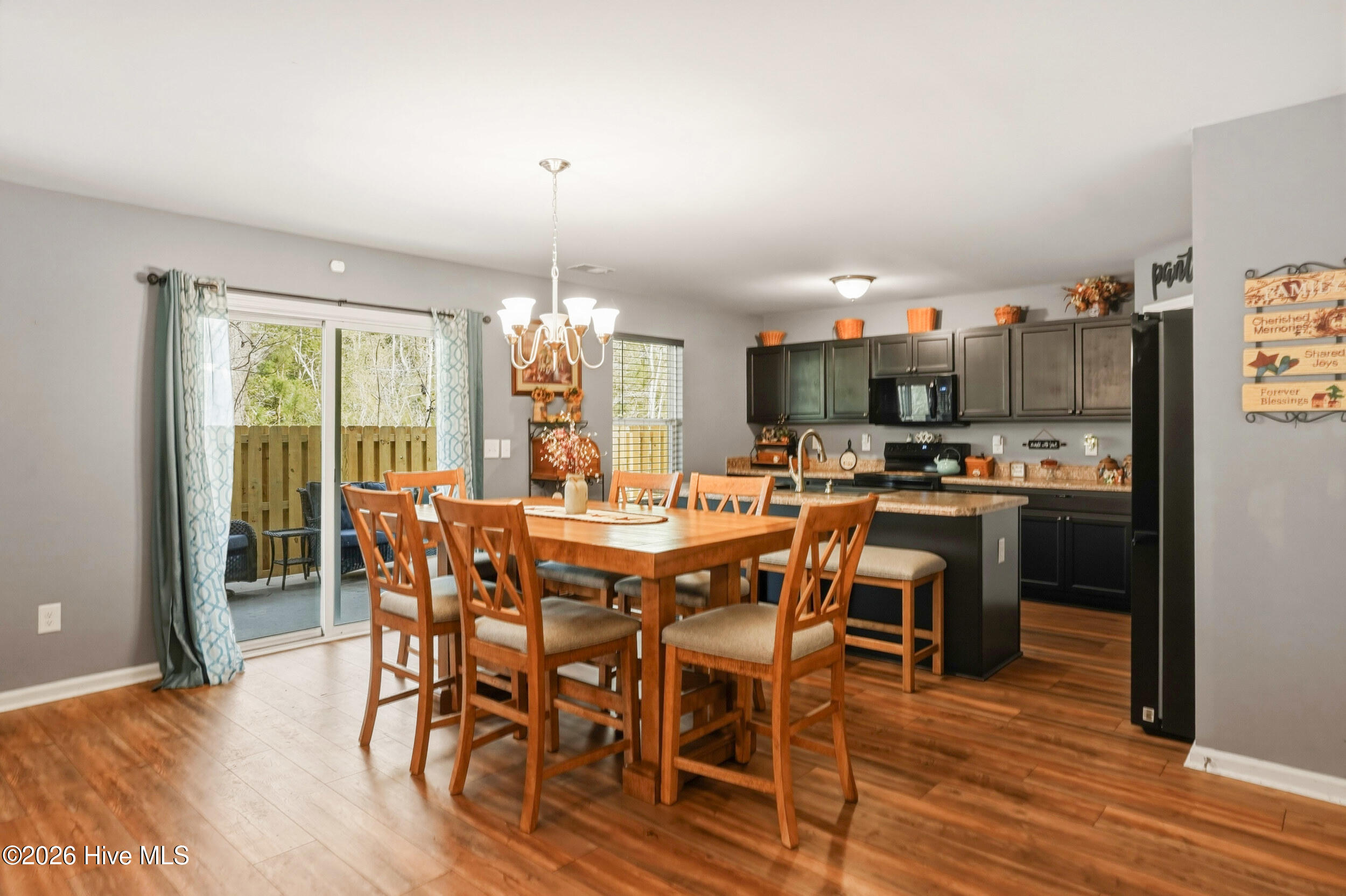 793 Landmark Cove Calabash, NC 28467 - Photo 11 of 53 Dining area and kitchen blend seamlessly within the open layout, featuring continuous LVP flooring and a functional design that supports both everyday use and easy entertaining.