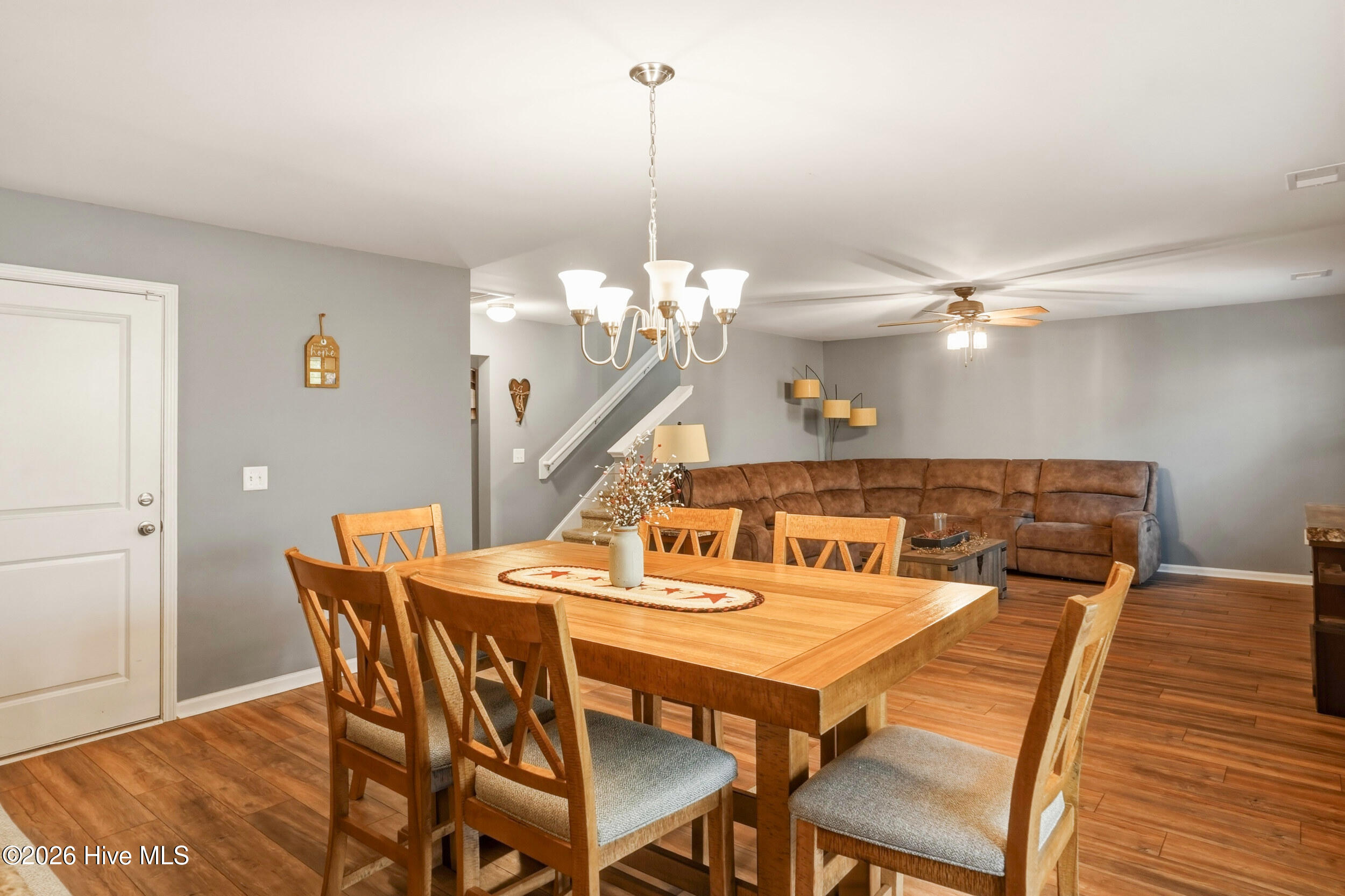 793 Landmark Cove Calabash, NC 28467 - Photo 12 of 53 View from the dining area into the living room, highlighting the open-concept design, abundant natural light, and smooth flow between the main living spaces.