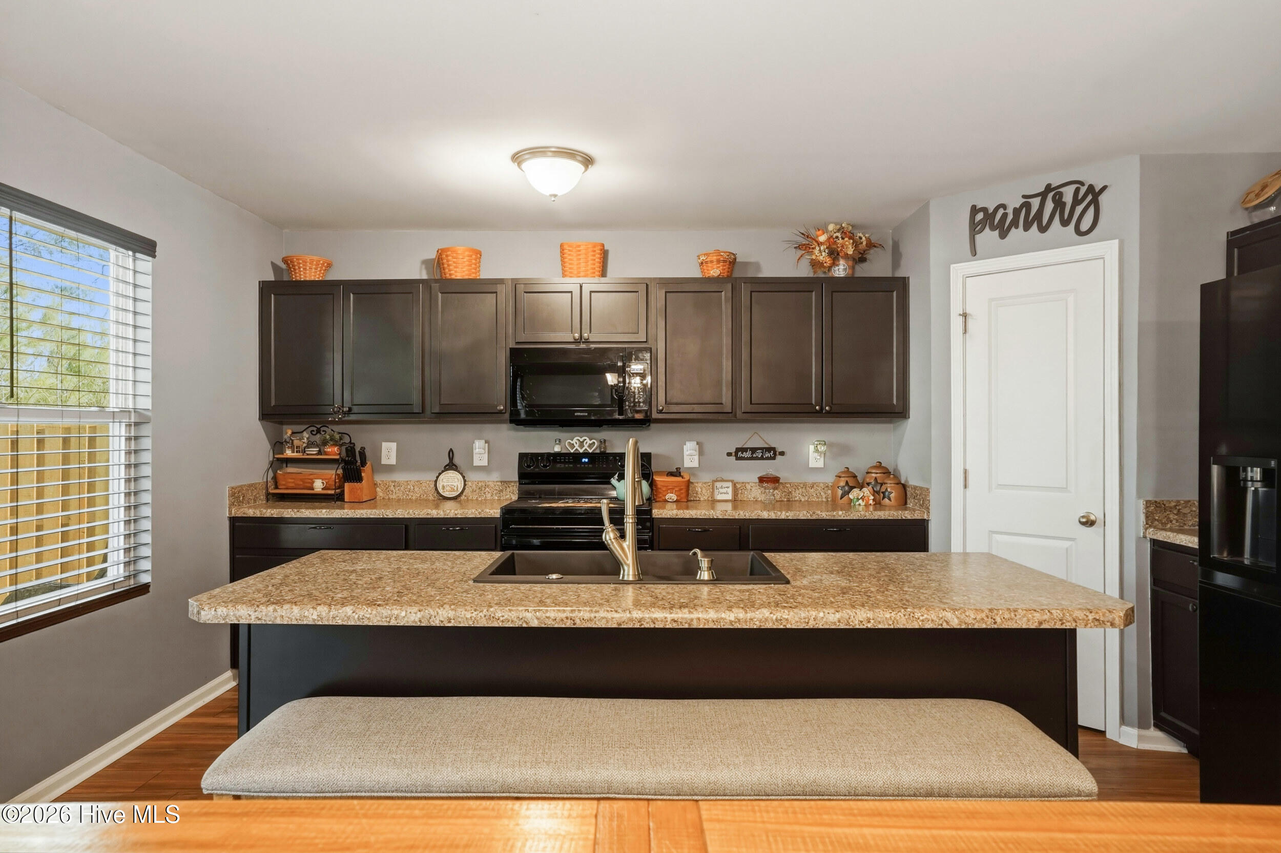 793 Landmark Cove Calabash, NC 28467 - Photo 14 of 53 Spacious kitchen featuring a large island with integrated sink, offering ample prep space and functional design for cooking and entertaining.