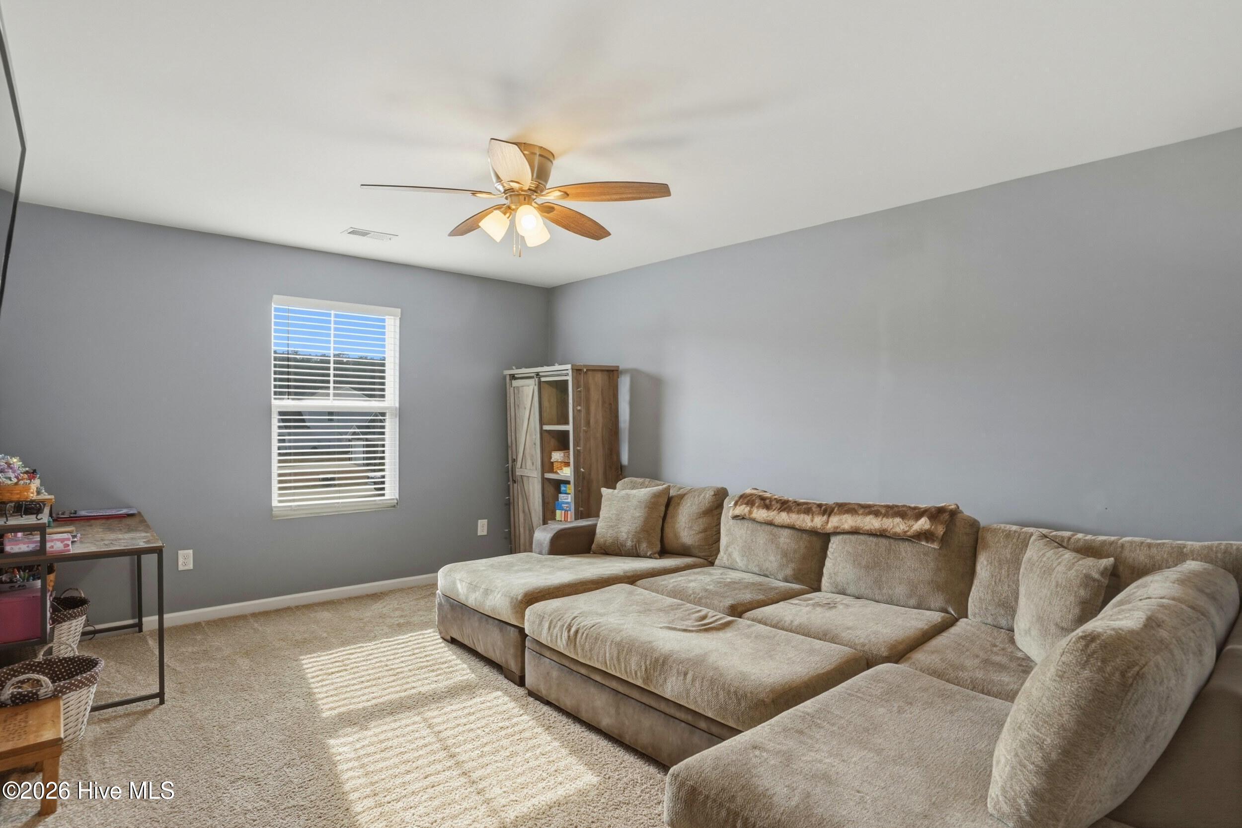 793 Landmark Cove Calabash, NC 28467 - Photo 21 of 53 Light-filled upstairs family/flex space with a ceiling fan, offering a bright and open area adaptable for a variety of uses.