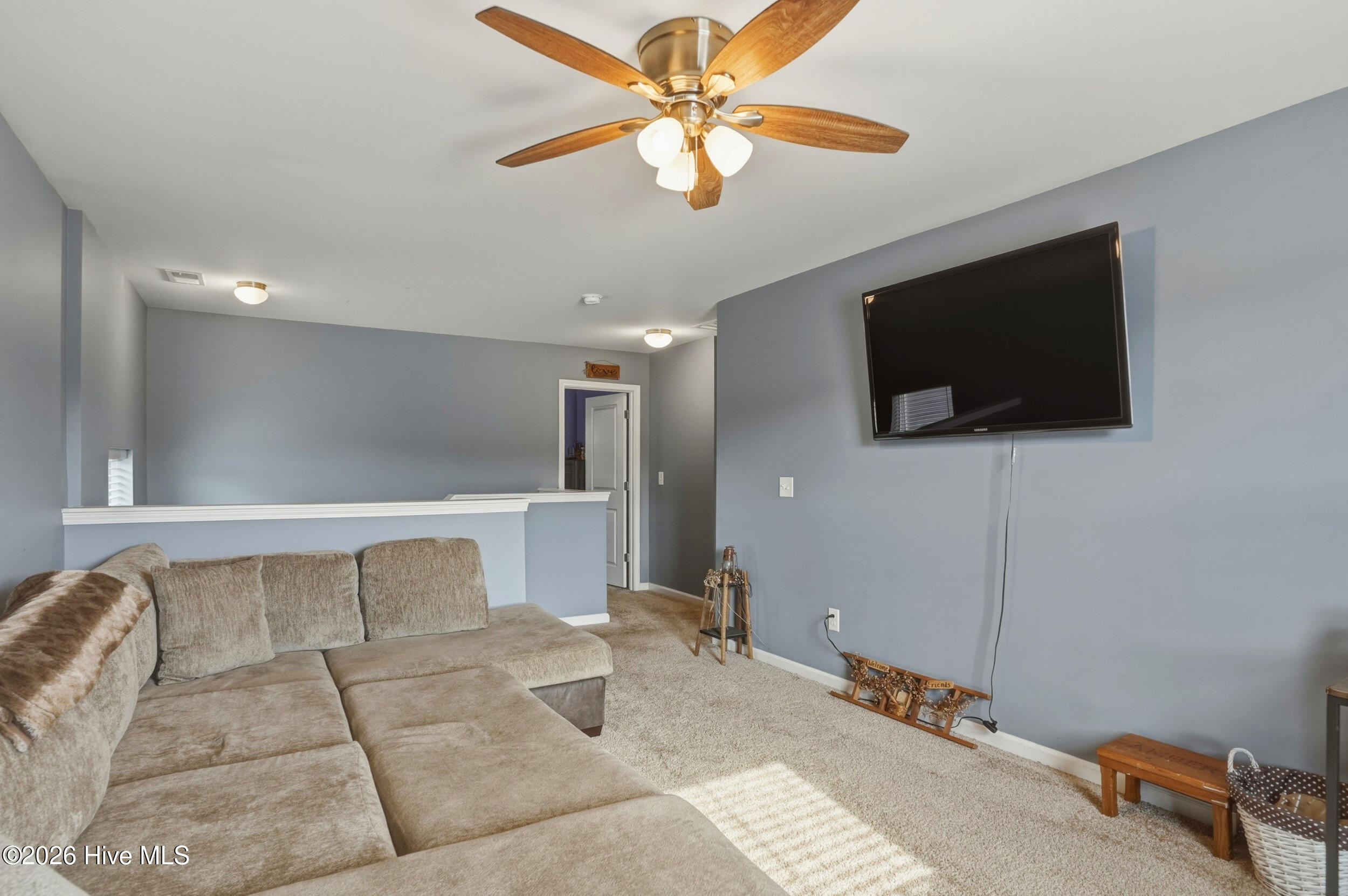 793 Landmark Cove Calabash, NC 28467 - Photo 22 of 53 Spacious upstairs area featuring abundant natural light, a ceiling fan, and flexible layout, ideal for multiple functional possibilities.