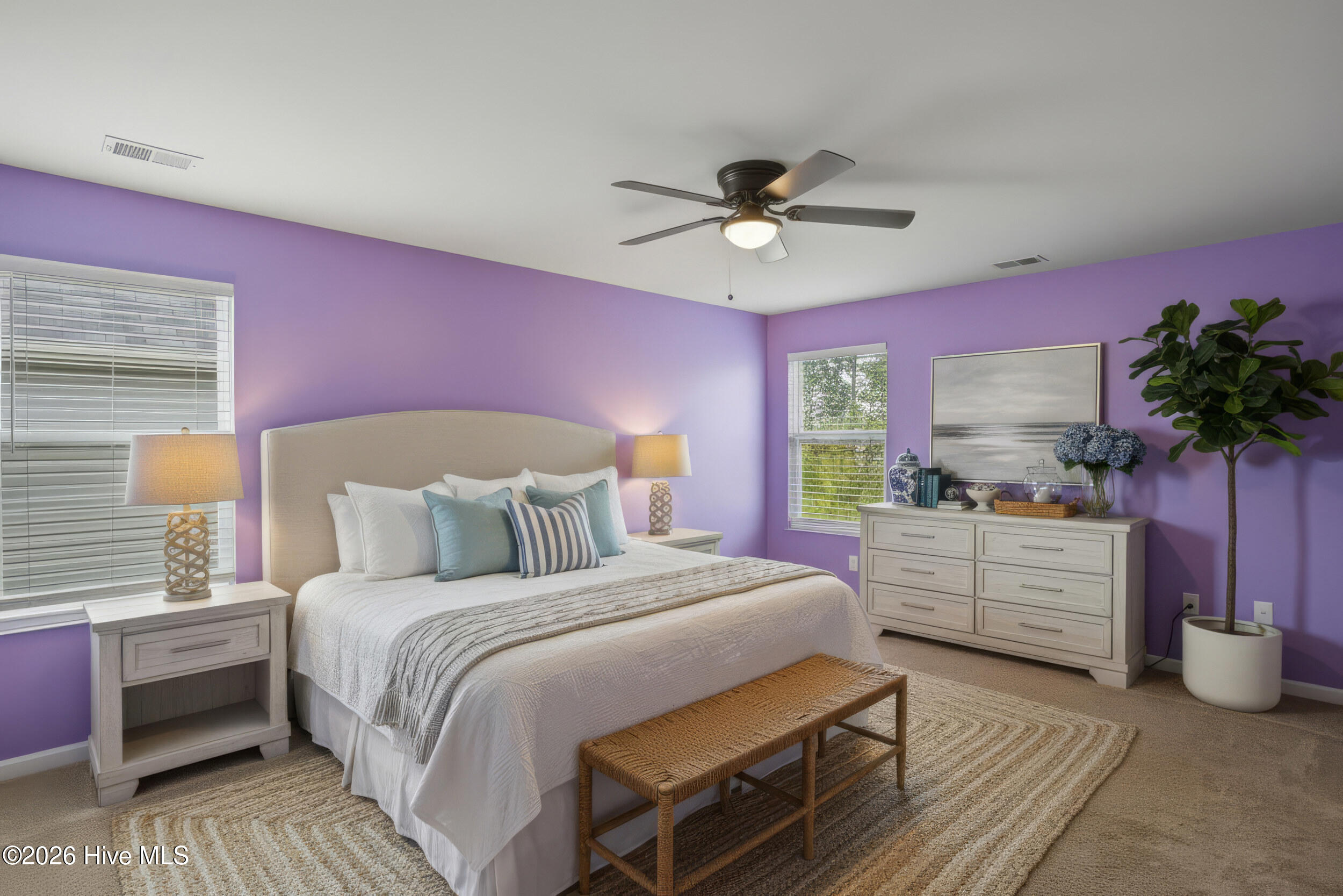 793 Landmark Cove Calabash, NC 28467 - Photo 23 of 53 Bright and spacious primary bedroom with carpeted flooring and abundant natural light, virtually staged to highlight the room’s versatility and potential design possibilities.
