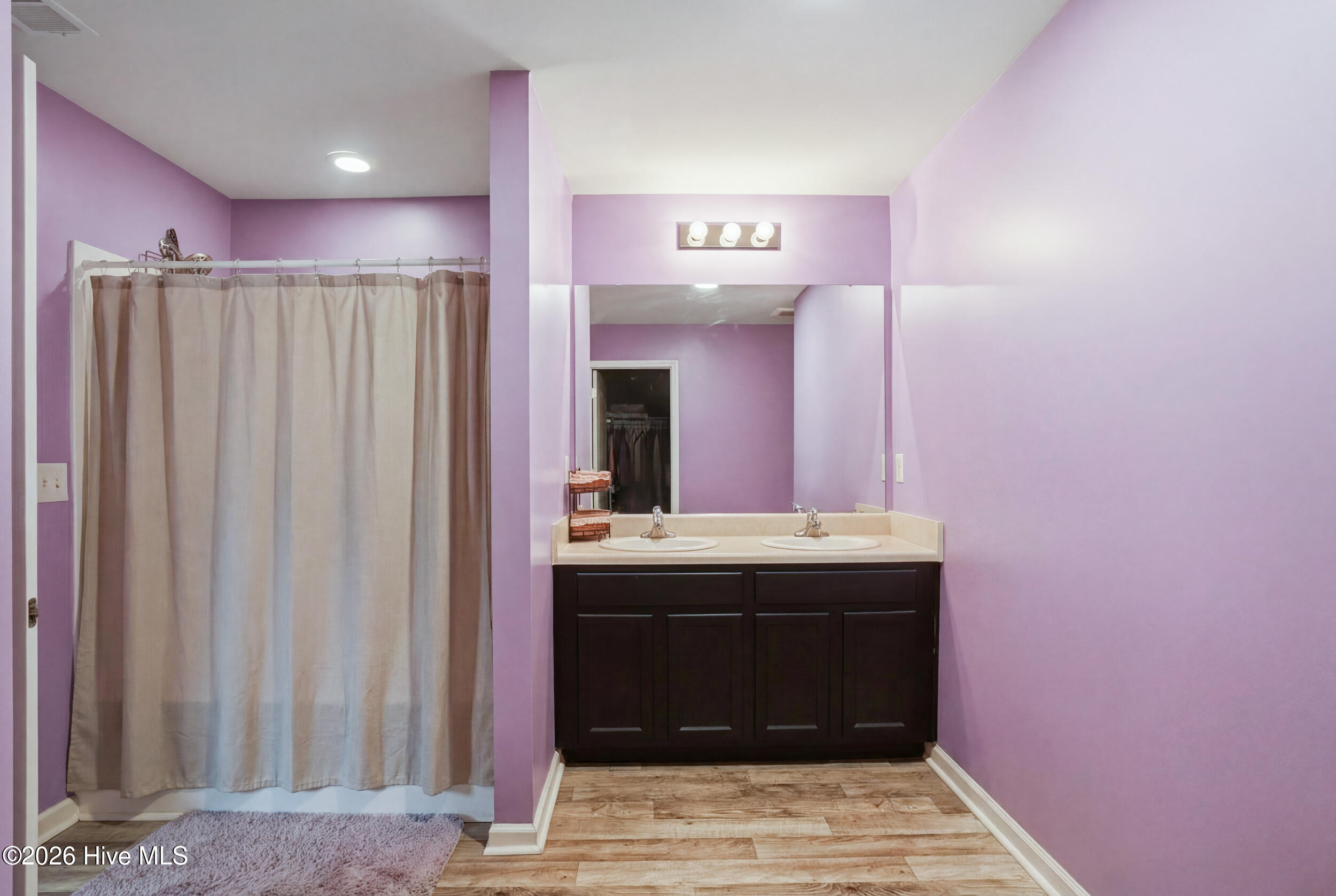 793 Landmark Cove Calabash, NC 28467 - Photo 27 of 53 Spacious primary bathroom featuring a double vanity and a walk-in shower, offering a bright, functional, and elegant retreat.
