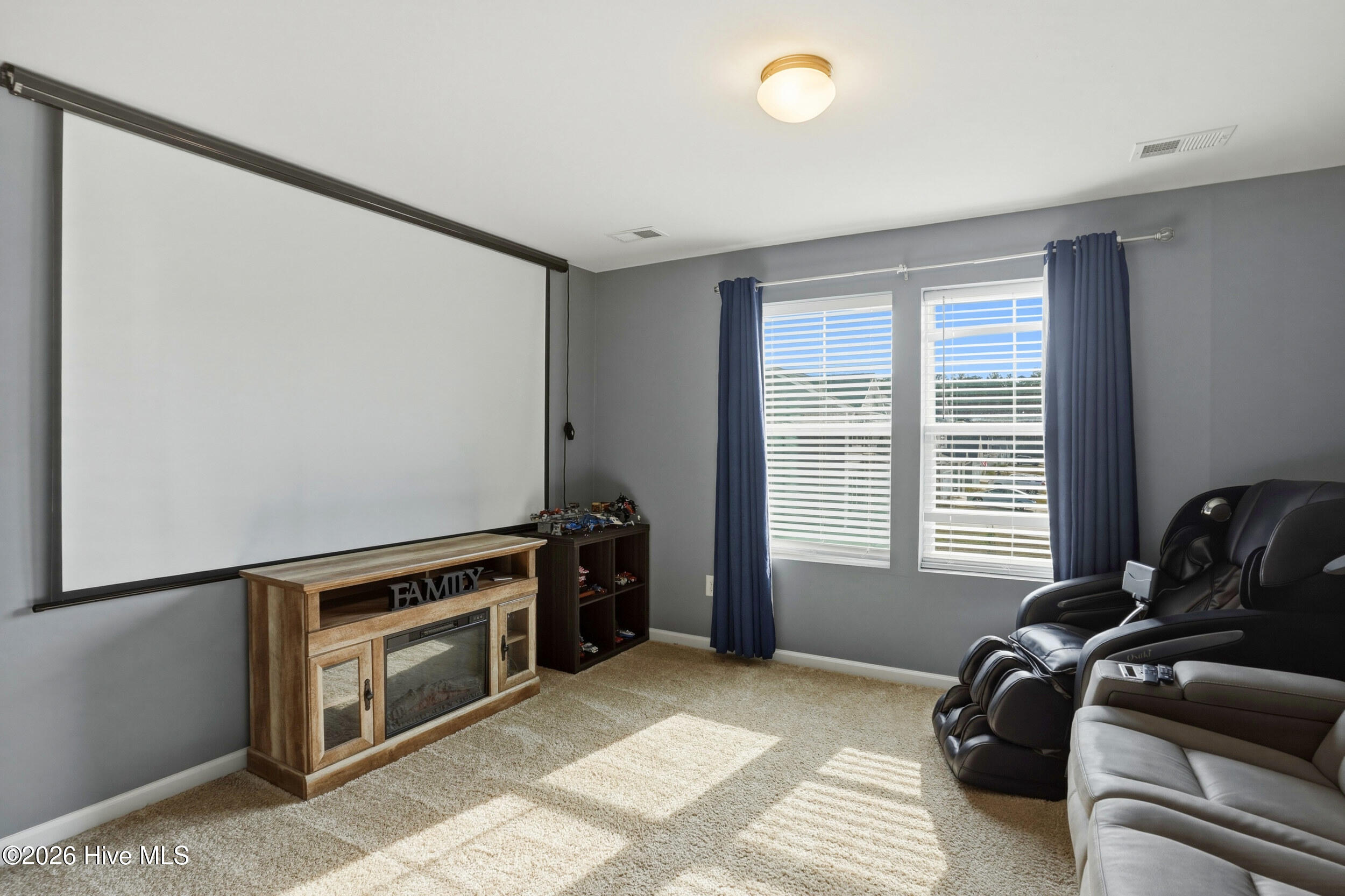 793 Landmark Cove Calabash, NC 28467 - Photo 28 of 53 Light-filled upstairs media room with a flexible layout, offering ample space for entertainment or adaptable use.
